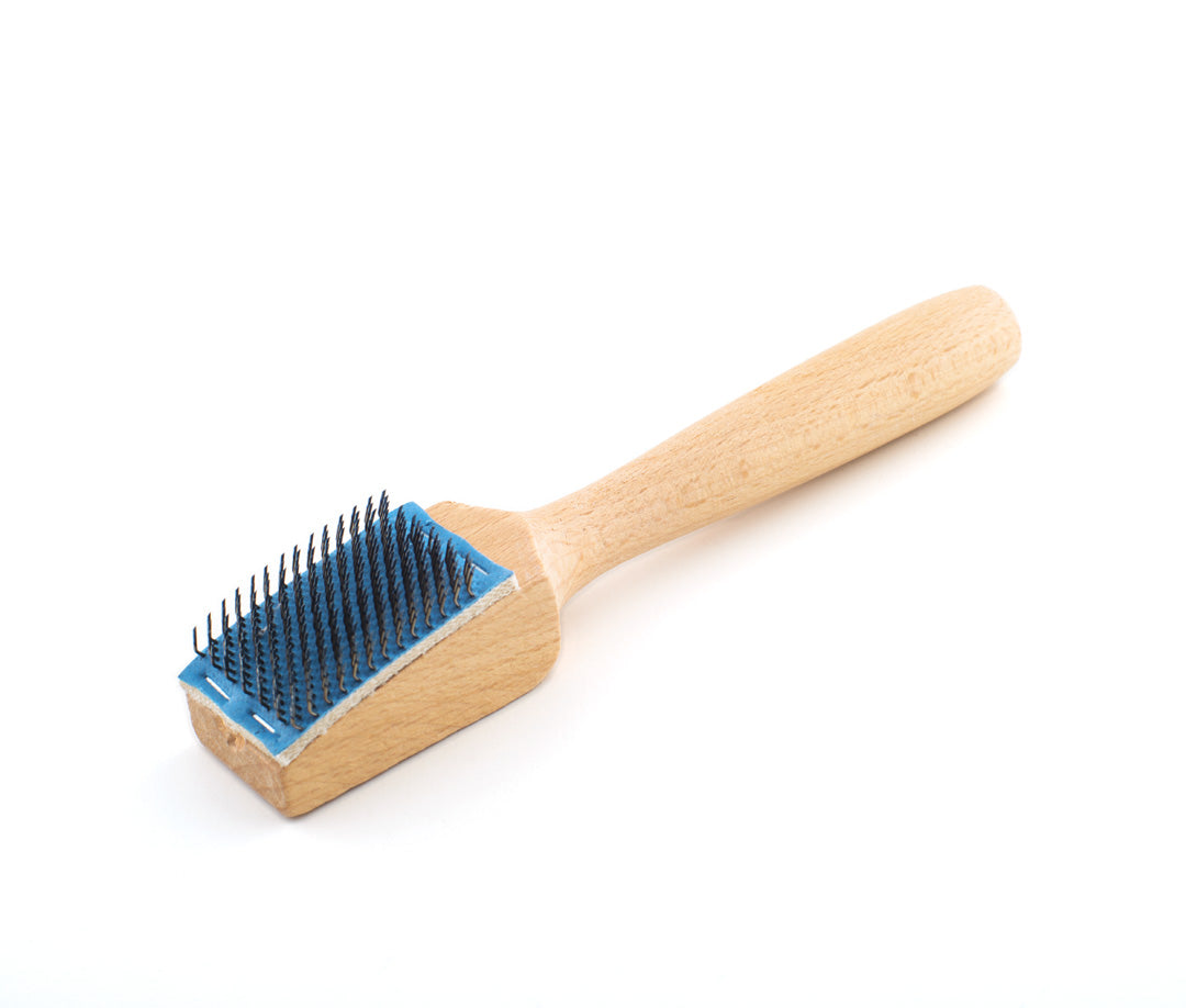 Wooden-handled brush for cleaning and maintaining suede dance shoe soles. Ideal for restoring grip and prolonging footwear durability.