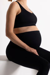 Pregnant woman wearing Hey Honey Maternity Black leggings and top, showcasing comfort and style during pregnancy.