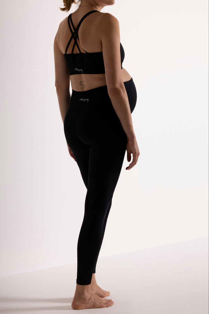 Pregnant woman wearing Hey Honey Maternity Black Leggings, showcasing comfort and support with a stylish design.