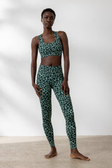 Model wearing Hey Honey Leo Jade leggings and sports bra featuring stylish leopard print and high waist design.