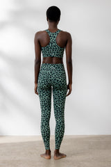 Model in green leopard print Bra Leo Jade and matching leggings, showcasing comfortable and breathable activewear.