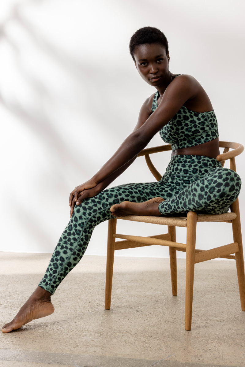 Model wearing Hey Honey Yoga Leo Jade leggings and top, showcasing stylish leopard print and comfortable fit.