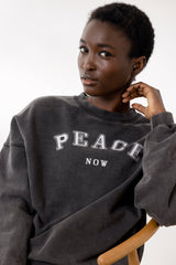 Model wearing Hey Honey Yoga Peace Sweater in comfortable fabric, showcasing casual style and positive message.