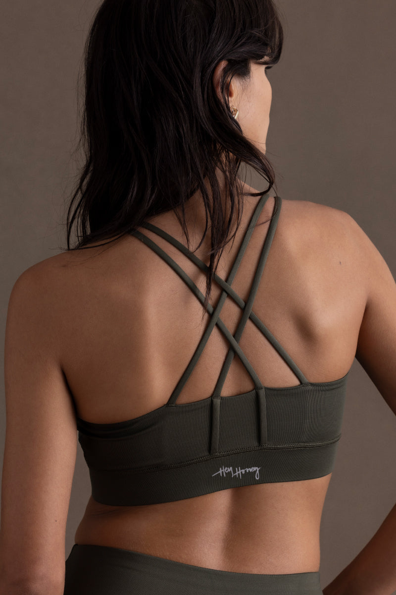 Women’s Hey Honey Criss-Cross Bra in Forest Night, showcasing stylish back design and comfortable fit for yoga and fitness.