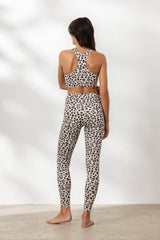 Model wearing Hey Honey Leo Clay leggings and matching sports bra, showcasing stylish leopard print design from the back.
