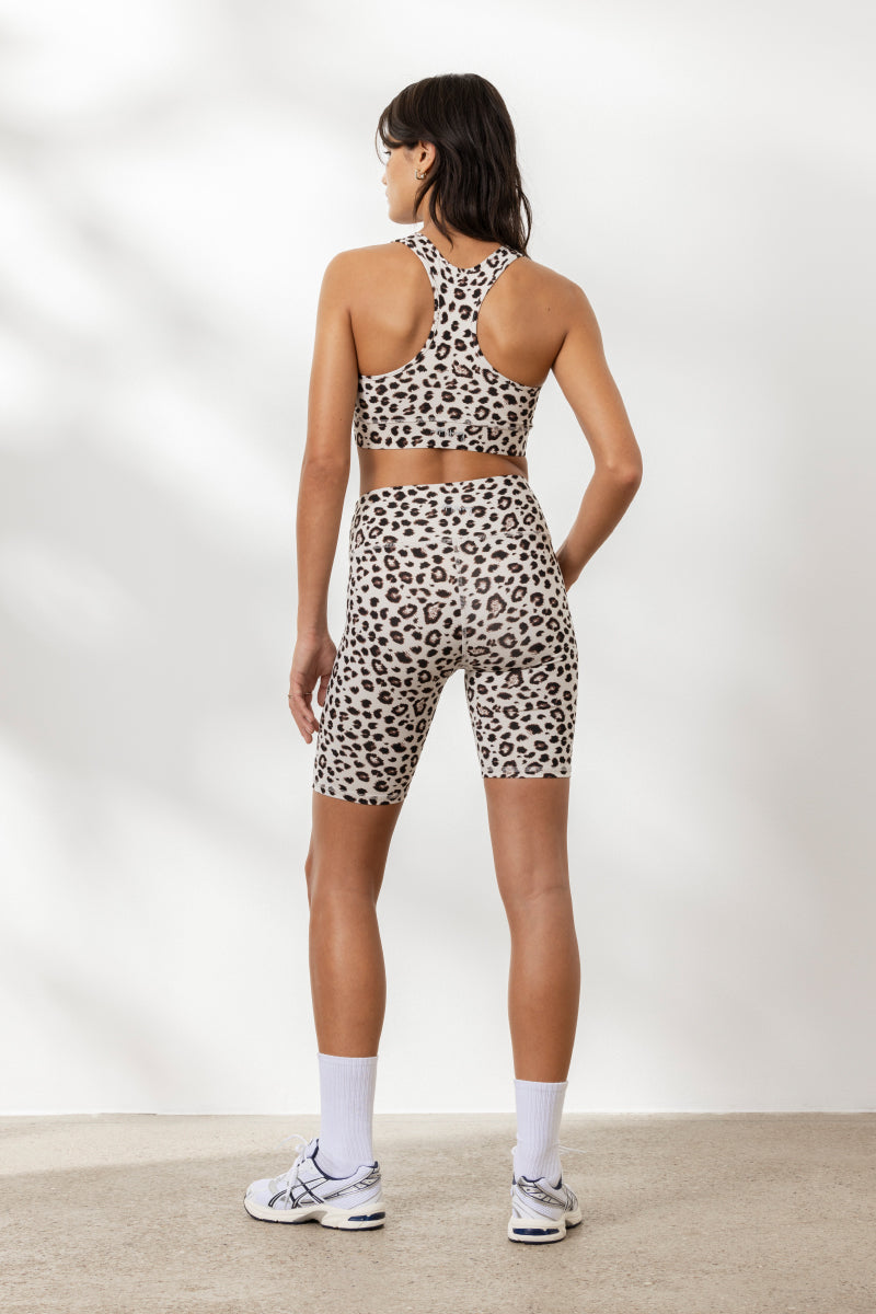 Model wearing Hey Honey Yoga Biker Leo Clay set, featuring a high waist and leopard print design for stylish comfort.