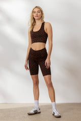 Model wearing Hey Honey Yoga Biker Leo Chocolate set featuring leopard print, high waist, and breathable stretch fabric.