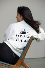 Off-white Voyage sweater showcased on model, featuring stylish back design, perfect for casual and studio wear.