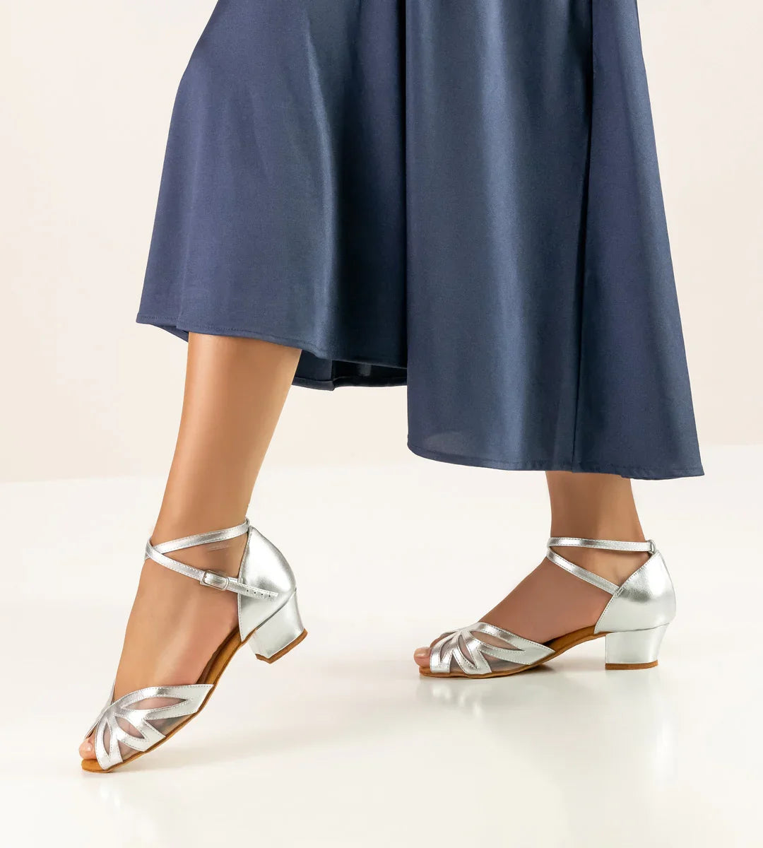 Werner Kern Fabienne silver dance shoes with adjustable straps, worn with a flowing navy skirt.