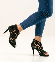 Elegant Anna Kern Fleur dance shoes with open toe and intricate design, paired with fitted jeans.