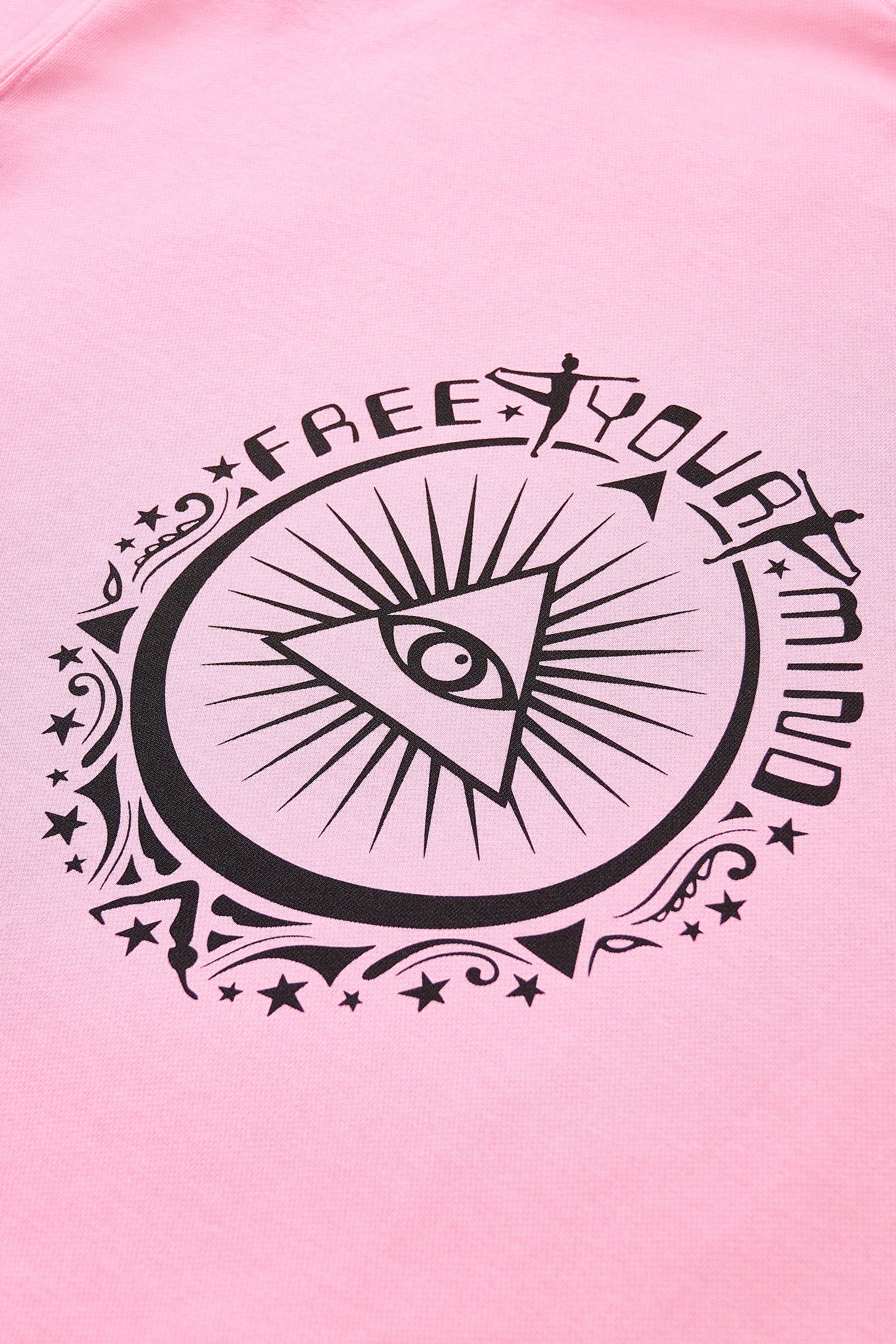 Pink sweatshirt featuring a black eye graphic with "FREE YOUR MIND" text and decorative elements.