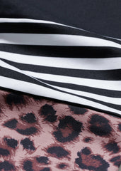 Close-up of Hey Honey Yoga leggings showing trendy leopard print in soft rose and stylish black and white stripes.