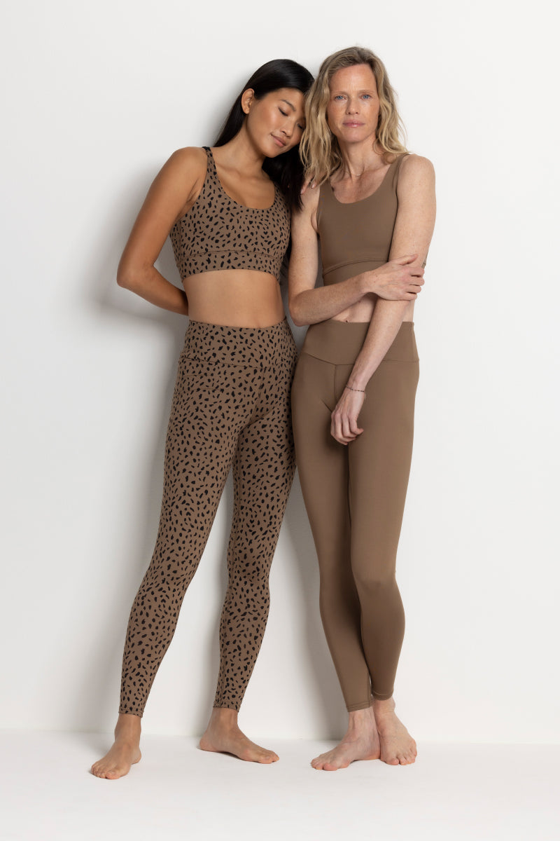 Two models showcasing Hey Honey Yoga leggings in Caribou color, emphasizing style and comfort for active wear.